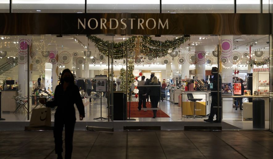 A security guard, right, stands at the entrance to a Nordstrom department store at the Grove mall in Los Angeles, Thursday, Dec. 2, 2021, where a recent smash-and-grab robbery took place. Prosecutors and retailers are pushing back on assertions by California’s governor and attorney general that they have enough tools to combat shoplifting. California Retailers Association president Rachel Michelin says shoplifting has been a growing problem.(AP Photo/Jae C. Hong)