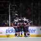 Washington Capitals left wing Alex Ovechkin (8) celebrates his goal with defenseman Martin Fehervary (42), right wing Tom Wilson (43) and others during the second period of an NHL hockey game against the Columbus Blue Jackets-, Saturday, Dec. 4, 2021, in Washington. (AP Photo/Nick Wass)