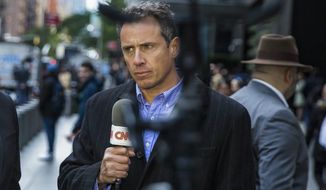 CNN correspondent Chris Cuomo during on air report in front of the Time Warner Building, where NYPD personnel removed an explosive device Wednesday, Oct. 24, 2018, in New York. CNN fired Cuomo for the role he played in defense of his brother, former Gov. Andrew Cuomo, as he fought sexual harassment charges. CNN said Saturday, Dec. 4, 2021, it was still investigating but additional information had come to light. (AP Photo/Kevin Hagen, File)