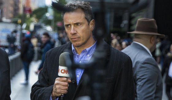 CNN correspondent Chris Cuomo during on-air report in front of the Time Warner Building, where NYPD personnel removed an explosive device Wednesday, Oct. 24, 2018, in New York. CNN fired Cuomo for the role he played in defense of his brother, former Gov. Andrew Cuomo, as he fought sexual harassment charges. CNN said Saturday, Dec. 4, 2021, it was still investigating but additional information had come to light. (AP Photo/Kevin Hagen, File)