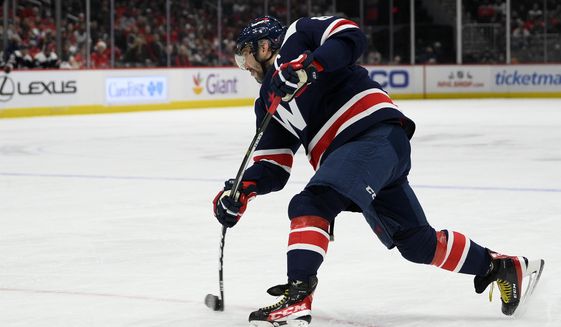 Washington Capitals left wing Alex Ovechkin (8) shoots the puck during the first period of an NHL hockey game against the Columbus Blue Jackets, Saturday, Dec. 4, 2021, in Washington. (AP Photo/Nick Wass)