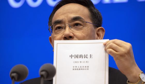 Xu Lin, vice minister of the Publicity Department of the Central Committee of China&#39;s Communist Party holds a copy of a government-produced report titled &amp;quot;Democracy that Works&amp;quot; during a press conference at the State Council Information Office in Beijing, Saturday, Dec. 4, 2021. China&#39;s Communist Party took American democracy to task on Saturday, sharply criticizing a global democracy summit being hosted by President Joe Biden next week and extolling the virtues of its governing system. (AP Photo/Mark Schiefelbein)
