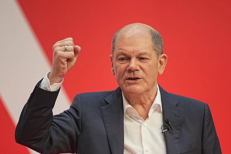 Olaf Scholz, SPD Chancellor-designate speaks at the SPD party conference at Willy Brandt House in Berlin, Germany, Saturday, Dec.4, 2021. Delegates vote on a coalition agreement with the FDP and Bündnis90/Die Grünen to form a new federal government. (Michael Kappeler/dpa via AP)