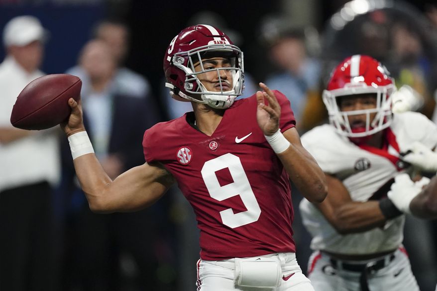 Alabama quarterback Bryce Young (9) passes in the pocket against Georgia during the first half of the Southeastern Conference championship NCAA college football game, Saturday, Dec. 4, 2021, in Atlanta. (AP Photo/John Bazemore)