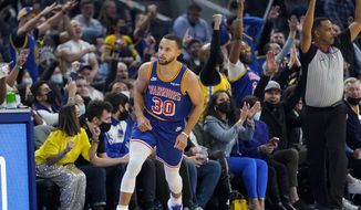 Golden State Warriors guard Stephen Curry (30) reacts in front of fans after shooting a 3-point basket against the Phoenix Suns during the first half of an NBA basketball game in San Francisco, Friday, Dec. 3, 2021. (AP Photo/Jeff Chiu) **FILE**