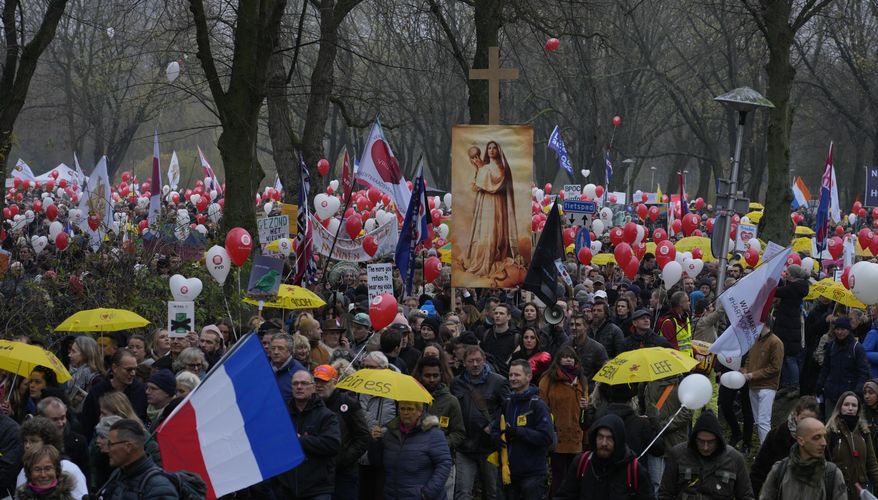 Thousands of demonstrators march in Utrecht, Netherlands, Saturday, Dec. 4, 2021, to protest against COVID-19 restrictions and the lockdown. (AP Photo/Peter Dejong)