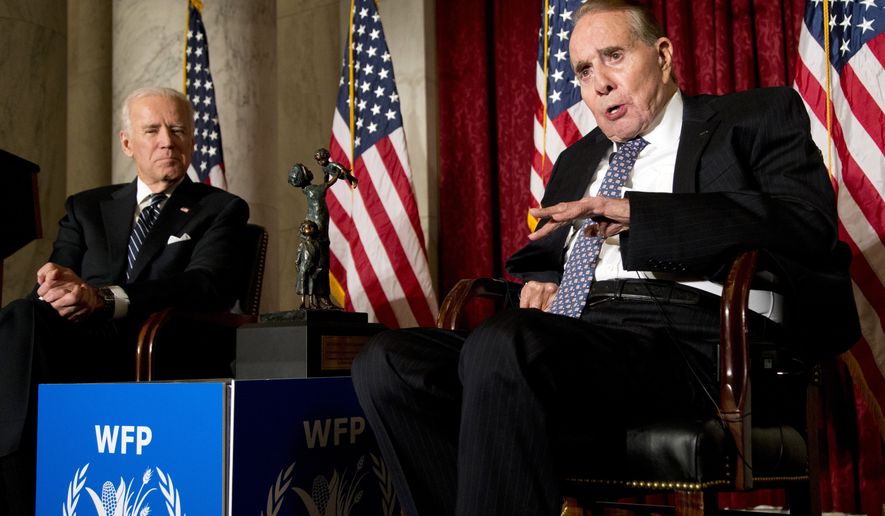 FILE - Former Senate Majority Leader Bob Dole, right, speaks after being presented with the McGovern-Dole Leadership Award by Vice President Joe Biden, left, to honor his leadership in the fight against hunger, during the 12th Annual George McGovern Leadership Award Ceremony hosted by World Food Program USA, on Capitol Hill in Washington, Dec. 11, 2013. (AP Photo/Manuel Balce Ceneta, File)