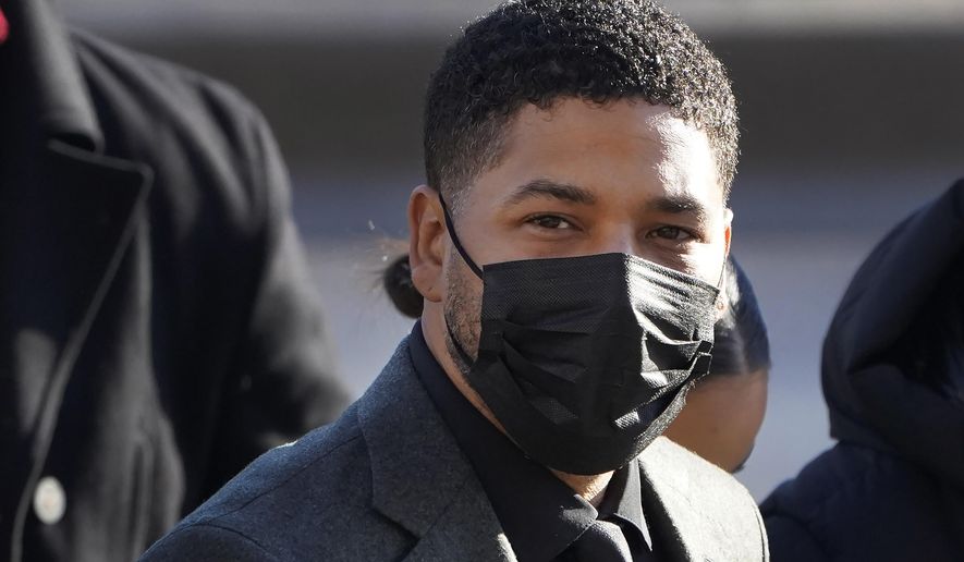 FILE - Actor Jussie Smollett arrives Tuesday, Nov. 30, 2021, at the Leighton Criminal Courthouse for day two of his trial in Chicago.  After two brothers spent hours telling a jury how Smollett paid them to carry out a fake racist and anti-gay attack on himself, the big question when the trial resumes Monday, Dec. 6, is whether the actor will tell his side.   (AP Photo/Charles Rex Arbogast, File)