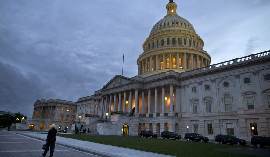 This Oct. 15, 2013, photo, shows a view of the U.S. Capitol building at dusk in Washington. (AP Photo/ Evan Vucci)