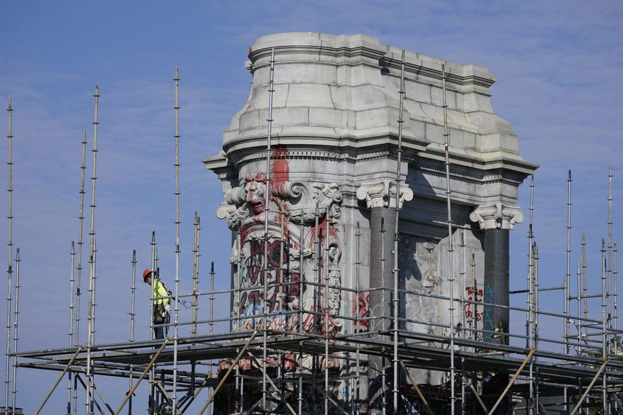 Workers install scaffolding as they prepare to remove the pedestal that once held the statue of Confederate General Robert E. Lee on Monument Avenue Monday Dec 6, 2021, in Richmond, Va. Virginia Gov. Ralph Northam ordered the pedestal removed and the land granted to the City of Richmond. (AP Photo/Steve Helber)