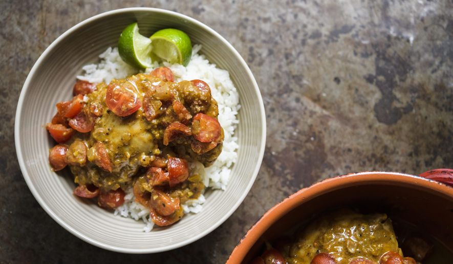This image released by Milk Street shows a recipe for Colombian coconut braised chicken. (Milk Street via AP)