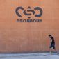 A logo adorns a wall on a branch of the Israeli NSO Group company, near the southern Israeli town of Sapir, Aug. 24, 2021. Israel’s Defense Ministry said in a statement Monday, Dec. 6, 2021, that it is tightening supervision over cyber exports — a move that follows a series of scandals involving Israeli spyware company NSO Group. The ministry said the countries purchasing Israeli cyber technology would have to sign a declaration pledging to use the products “for the investigation and prevention of terrorist acts and serious crimes only.” (AP Photo/Sebastian Scheiner, File)