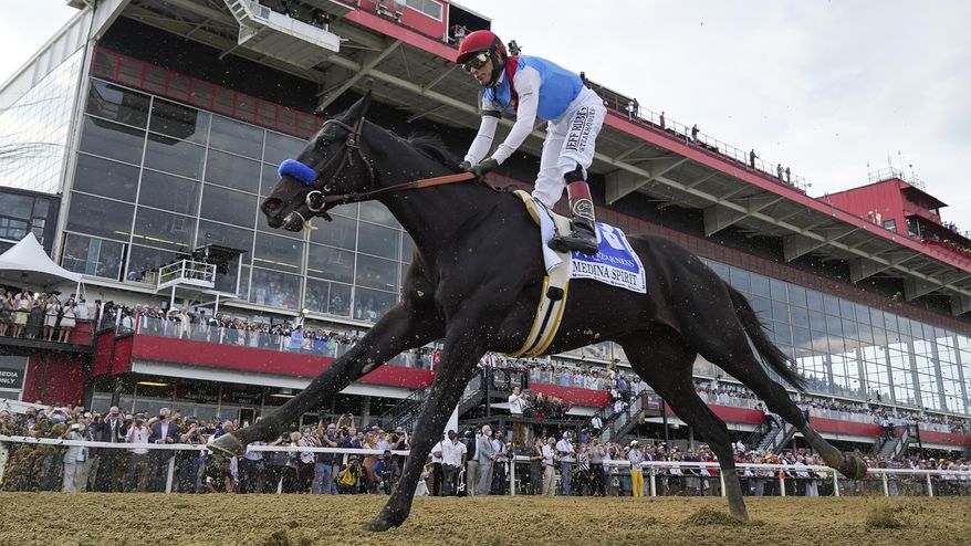 FILE - John Velazquez atop Medina Spirit competes during the 146th Preakness Stakes horse race at Pimlico Race Course, Saturday, May 15, 2021, in Baltimore. Kentucky Derby winner Medina Spirit collapsed and died after a workout Monday, Dec. 6, 2021, at Santa Anita. The 3-year-old colt trained by Bob Baffert had just completed five furlongs in his second workout since finishing second in the Breeders’ Cup Classic a month ago at Del Mar, according to Craig Robertson, Baffert’s attorney. (AP Photo/Julio Cortez, File)