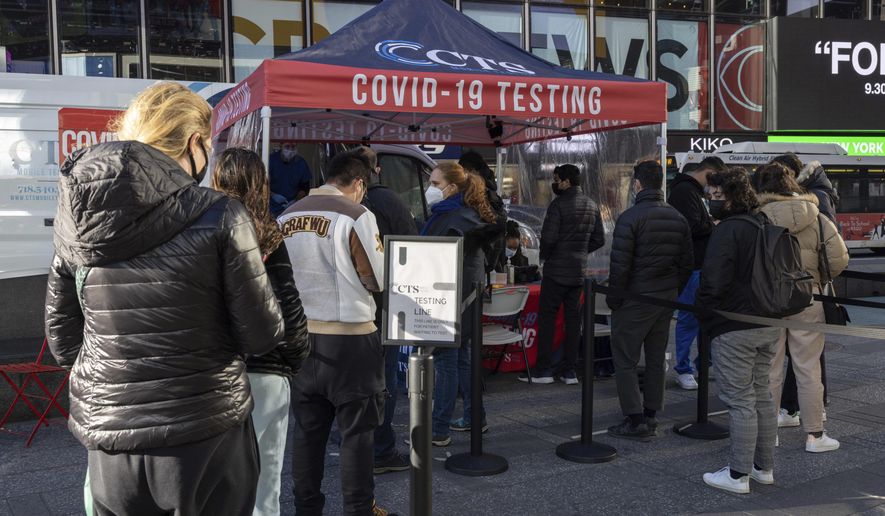 People wait in line at COVID-19 testing site in Times Square on Friday, Dec. 3, 2021, in New York. The omicron variant of COVID-19, which had been undetected in the U.S. before the middle of this week, had been discovered in at least five states by the end of Thursday, showing yet again how mutations of the virus can circumnavigate the globe with speed and ease.(AP Photo/Yuki Iwamura)