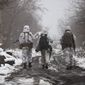 Ukrainian soldiers walks at the line of separation from pro-Russian rebels near Katerinivka, Donetsk region, Ukraine, Tuesday, Dec 7, 2021. The final portion of a $60 million U.S. security assistance package to Ukraine approved by President Biden is expected to arrive this week amid rising tensions with Moscow as hundreds of Russian troops continue massing along the border. (AP Photo/Andriy Dubchak)