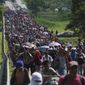 Migrants arrive in Villa Comaltitlan, Chiapas state, Mexico, Oct. 27, 2021, as they continue their journey through Mexico to the U.S. border. The Biden administration struck an agreement with Mexico to reinstate a Trump-era border policy next week that forces asylum-seekers to wait in Mexico for hearings in U.S. immigration court, U.S. officials said Thursday. (AP Photo/Marco Ugarte, File)