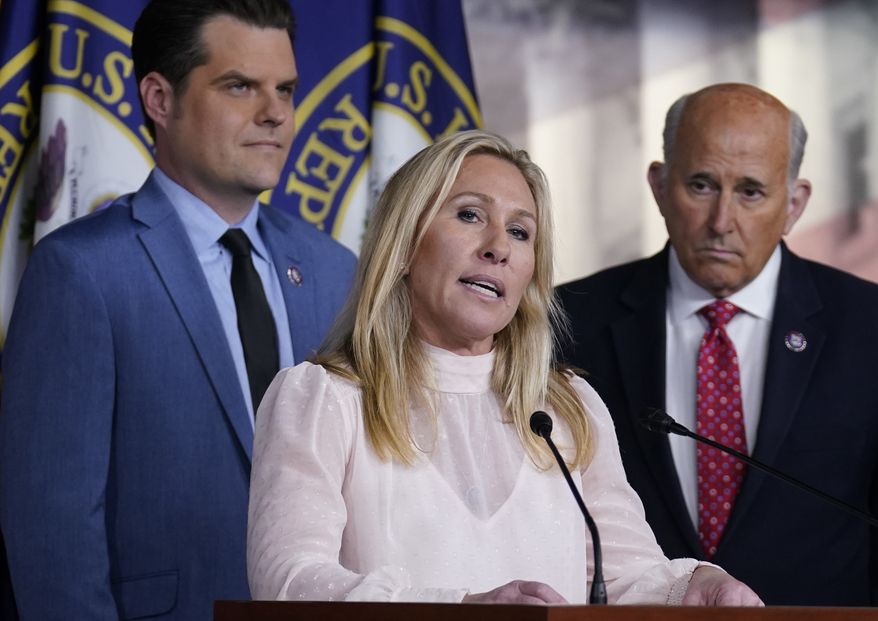 Rep. Marjorie Taylor Greene, R-Ga., joined at left by Rep. Matt Gaetz, R-Fla., and Rep. Louie Gohmert, R-Texas, right, speaks at a news conference about the treatment of people being held in the District of Columbia jail who are charged with crimes in the Jan. 6 insurrection, at the Capitol in Washington, Tuesday, Dec. 7, 2021. (AP Photo/J. Scott Applewhite)