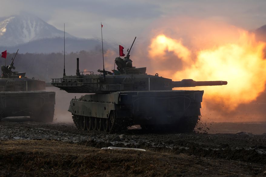 Japanese Ground-Self Defense Force (JGDDF) Type 90 tank fires its gun at a target during an annual drill exercise at the Minami Eniwa Camp Tuesday, Dec. 7, 2021, in Eniwa, Japan&#39;s northern island of Hokkaido. Dozens of tanks are rolling over the next two weeks on Hokkaido, a main military stronghold for a country with perhaps the world&#39;s most little known yet powerful army. (AP Photo/Eugene Hoshiko)