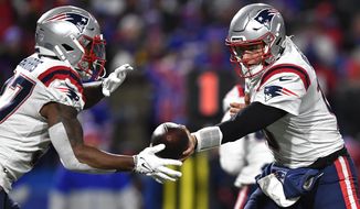 New England Patriots quarterback Mac Jones, left, hands off to cornerback J.C. Jackson during the first half of an NFL football game against the Buffalo Bills in Orchard Park, N.Y., Monday, Dec. 6, 2021. (AP Photo/Adrian Kraus) ** FILE **