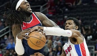 Detroit Pistons guard Josh Jackson (20) knocks the ball away from Washington Wizards center Montrezl Harrell during the first half of an NBA basketball game, Wednesday, Dec. 8, 2021, in Detroit. (AP Photo/Carlos Osorio)