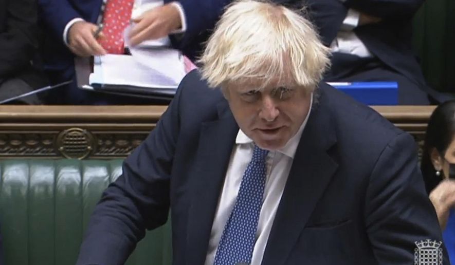 In this grab taken from video, Britain&#x27;s Prime Minister Boris Johnson speaks during Prime Minister&#x27;s Questions in the House of Commons, London, Wednesday, Dec. 8, 2021. Johnson says no U.K. government minister will attend the Beijing Olympics. Johnson on Wednesday called it “effectively” a diplomatic boycott. Johnson was asked in the House of Commons whether the U.K. will join the United States, Australia and Lithuania in a diplomatic boycott of the Winter Games. (House of Commons/PA via AP)