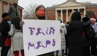 Amanda SubbaRao holds a sign calling for “Fair Maps” during a rally in Annapolis, Md., on Wednesday, Dec. 8, 2021. She was attending a rally opposing gerrymandering, in which politicians draw districts to benefit their party. The Maryland General Assembly is in a special session to approve a new congressional map for the state’s eight U.S. House seats after the recent census. (AP Photo/Brian Witte) **FILE**