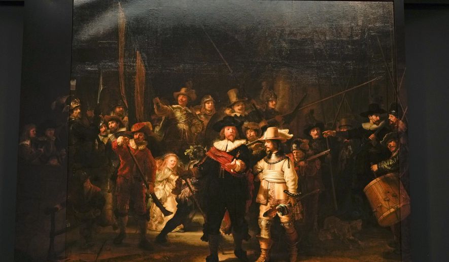 FILE - View of Rembrandt&#x27;s biggest painting the Night Watch which just got bigger with the help of artificial intelligence, see added sides, in Amsterdam, Netherlands, Wednesday, June 23, 2021. The Netherlands&#x27; national museum is planning to re-stretch Rembrandt van Rijn&#x27;s huge painting &amp;quot;The Night Watch,&amp;quot; to get rid of deformations in its top left corner, the Rijksmuseum announced Wednesday, Dec. 8, 2021. (AP Photo/Peter Dejong, File)