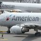 American Airlines passenger jets prepare for departure, Wednesday, July 21, 2021, near a terminal at Boston Logan International Airport, in Boston. (AP Photo/Steven Senne, File)