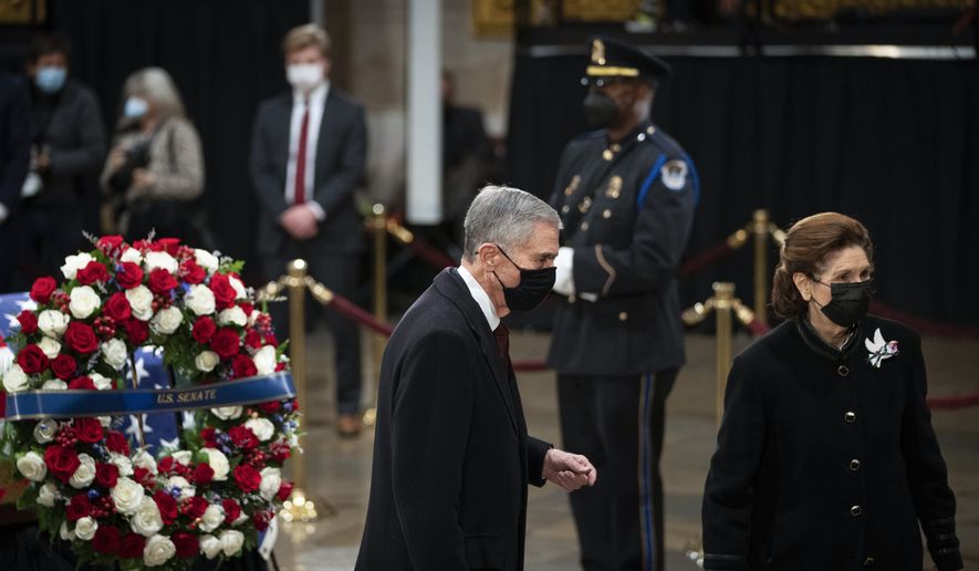 Former Virginia Gov. Chuck Robb, left, and wife Lynda Bird Johnson Robb, the eldest daughter of the 36th U.S. President Lyndon B. Johnson, pay their respects to former Sen. Bob Dole of Kansas as he lies in state in the Rotunda of the U.S. Capitol in Washington, Thursday, Dec. 9, 2021. (Sarahbeth Maney/The New York Times via AP, Pool) ** FILE **