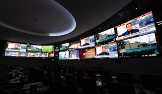 Screens are seen at the new MGM National Harbor sportsbook, Thursday, Dec. 9, 2021, in Oxon Hill, Md. Maryland officially started taking sports bets Thursday, when Larry Hogan was among the first people to make a sports wager at the casino. (AP Photo/Julio Cortez)