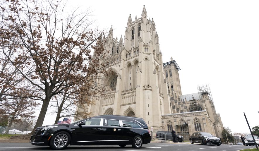 The hearse carrying the flag-draped casket of former Sen. Bob Dole of Kansas, leaves the Washington National Cathedral following a funeral service, Friday, Dec. 10, 2021, in Washington. (AP Photo/Manuel Balce Ceneta) ** FILE **