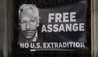 A view of a banner that Julian Assange supporters fixed to a railing, outside the High Court in London, Friday, Dec. 10, 2021. (AP Photo/Frank Augstein) ** FILE **