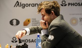 Magnus Carlsen of Norway competes during the FIDE World Championship at Dubai Expo 2020 in Dubai, United Arab Emirates, Friday, Dec. 10, 2021. (AP Photo/Jon Gambrell) ** FILE **