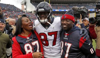 Houston Texans wide receiver Demaryius Thomas stands with his parents, Bobby Thomas, right, and Katina Smith, prior to the team&#39;s NFL football game against the Denver Broncos on Nov. 4, 2018, in Denver. Thomas, who eared five straight Pro Bowls and a Super Bowl ring during a prolific receiving career spent mostly with the Broncos, has died at the age of 33. Thomas was found dead in his suburban Atlanta home Thursday night, Dec. 9, 2021, said Officer Tim Lupo, public information officer for the police department in Roswell, Ga. (AP Photo/David Zalubowski, File)