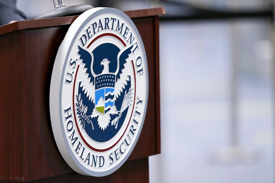 A U.S. Department of Homeland Security plaque is displayed a podium as international passengers arrive at Miami international Airport where they are screened by U.S. Customs and Border Protection, Nov. 20, 2020, in Miami. A special Customs and Border Protection unit used sensitive government databases intended to track terrorists to investigate as many as 20 U.S.-based journalists, including a Pulitzer Prize-winning Associated Press reporter, according to a federal watchdog. (AP Photo/Lynne Sladky, File)