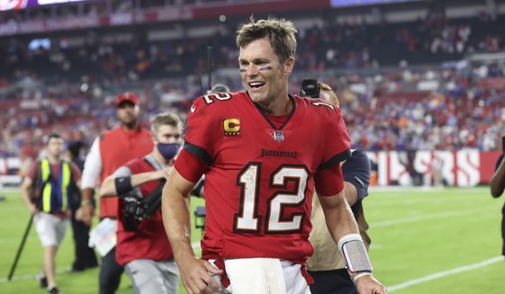 Tampa Bay Buccaneers quarterback Tom Brady (12) smiles as he leaves the field after the team defeated the Buffalo Bills during overtime of an NFL football game Sunday, Dec. 12, 2021, in Tampa, Fla. (AP Photo/Mark LoMoglio)