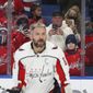 Fans watch and take photos as Washington Capitals left wing Alex Ovechkin (8) warms up before an NHL hockey game against the Buffalo Sabres on Saturday, Dec. 11, 2021, in Buffalo, N.Y. (AP Photo/Joshua Bessex)