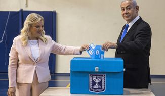 Israeli Prime Minister Benjamin Netanyahu and his wife Sarah casts their votes at a voting station in Jerusalem, Sept. 17, 2019. On Sunday Dec. 12, 2021, an Israeli parliamentary committee voted to stop providing personal security details to former prime minister Benjamin Netanyahu’s wife and adult sons. The decision comes six months after the longtime leader was ousted from power. As opposition leader, he will continue to have a security detail and private driver. (Heidi Levine, Sipa, Pool via AP, File).