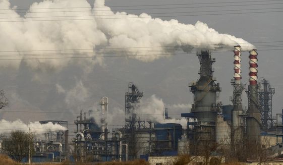 FILE - In this Nov. 28, 2019, file photo, smoke and steam rise from a coal processing plant in Hejin in central China&#39;s Shanxi Province. China and U.S. had a “very good year” for collaboration on dealing with climate change, but Washington is still pushing Beijing to adopt more ambitious carbon reduction goals, the top U.S. diplomat in China says. (AP Photo/Olivia Zhang, File)