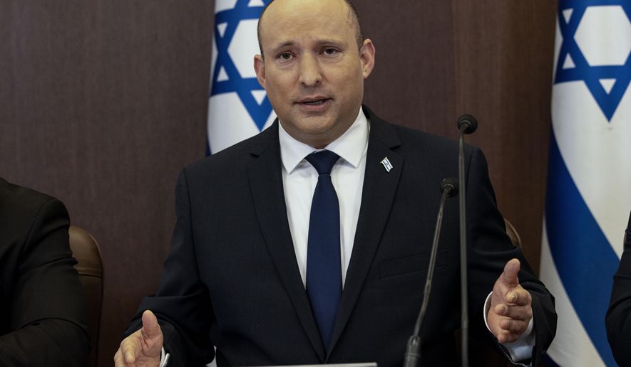 Israeli Prime Minister Naftali Bennett chairs the weekly cabinet meeting in Jerusalem, Sunday, Dec. 12, 2021. Bennett announced that he would make the first official visit by a sitting premier to the United Arab Emirates on Sunday as part of a blitz of regional diplomacy amid the backdrop of struggling nuclear talks with Iran. (AP Photo/Tsafrir Abayov, Pool)