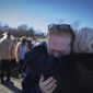 Tamara Yekinni hugs a friend outside a shelter in Wingo, Ky., on Sunday, Dec. 12, 2021, after residents were displaced by a tornado that caused severe damage in the area. Yekinni is an employee at a candle factory where employees were killed and injured by the storm. (AP Photo/Robert Bumsted)