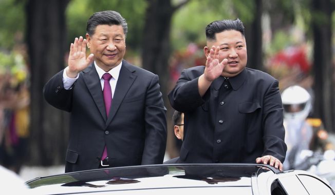 In this June 20, 2019, file photo released by China&#x27;s Xinhua News Agency, visiting Chinese President Xi Jinping, left, and North Korean leader Kim Jong Un wave from an open-top limousine as they travel along a street in Pyongyang, North Korea. Since taking power after his father’s death in 2011, Kim has spent 10 years erasing doubts that he was too young and weak to extend his family’s brutal dynastic grip over the impoverished, nuclear-armed state. (Ju Peng/Xinhua via AP, File)