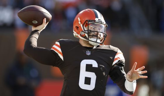 Cleveland Browns quarterback Baker Mayfield throws during the first half of an NFL football game against the Baltimore Ravens, Sunday, Dec. 12, 2021, in Cleveland. (AP Photo/Ron Schwane)