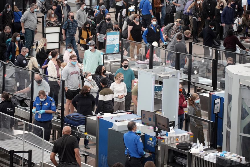 Travelers queue up at the south security checkpoint Nov. 23, 2021, at Denver International Airport in Denver. President Joe Biden on Monday, Dec. 13, 2021, will sign an executive order aimed at saving Americans time and frustration when seeking a broad array of federal services, like renewing passports, applying for Social Security benefits and getting aid after natural disasters. (AP Photo/David Zalubowski, File)