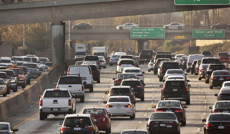Traffic travels along the Hollywood Freeway in Los Angeles on Dec. 12, 2018. According to a report published in the Proceedings of the National Academy of Sciences on Monday, Dec. 13, 2021, researchers who study the environment and public health say that thousands of lives and hundreds of billions of dollars have been saved in the United States by recent reductions in emissions from vehicles. (AP Photo/Damian Dovarganes, File)
