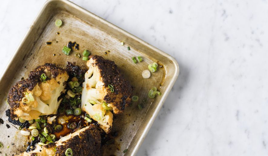This image released by Milk Street shows a recipe for chili-garlic roasted whole cauliflower. (Milk Street via AP)