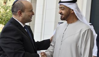 In this photo provided by the Israel Government Press Office (GPO), Israeli Prime Minister Naftali Bennett, left, is received by Abu Dhabi Crown Prince Sheikh Mohammed bin Zayed at his private palace in Abu Dhabi, Monday, Dec. 13, 2021. (Haim Zach/Israel Government Press Office via AP)