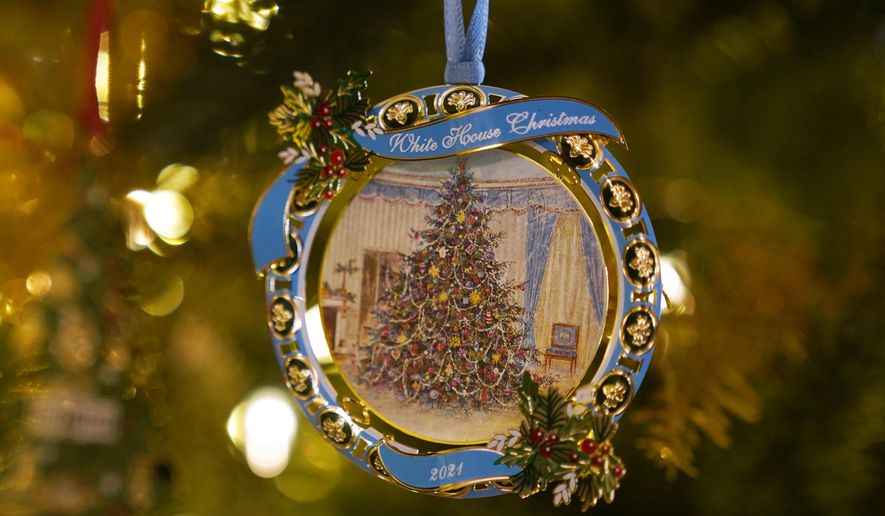The White House Historical Association&#x27;s 2021 Christmas tree ornament that honors President Lyndon Johnson hangs on a tree in the St. Regis Hotel in Washington, Friday, Dec. 10, 2021. The 2021 official White House ornament, the 41st in the series, honors President Johnson with its reproduction of a painting of the Blue Room tree the family had in December 1967. (AP Photo/Susan Walsh)