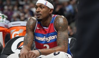 Washington Wizards guard Bradley Beal looks on from the bench in the first half of an NBA basketball game against the Denver Nuggets, Monday, Dec. 13, 2021, in Denver. (AP Photo/David Zalubowski)