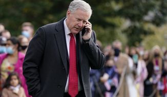 FILE - White House Chief of Staff Mark Meadows speaks on a phone on the South Lawn of the White House in Washington, on Oct. 30, 2020. A revelation about text messages sent by three Fox News personalities to Meadows, former President Donald Trump&#39;s chief of staff, on the day of the Capitol riots raise questions about whether they have lost sight of the news aspect of their jobs. (AP Photo/Patrick Semansky, File)